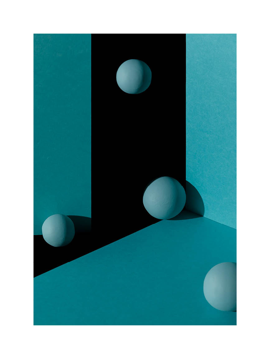 Abstrakt minimalistiskt fotografi i blå toner med sfäriska former och geometriska ytor.