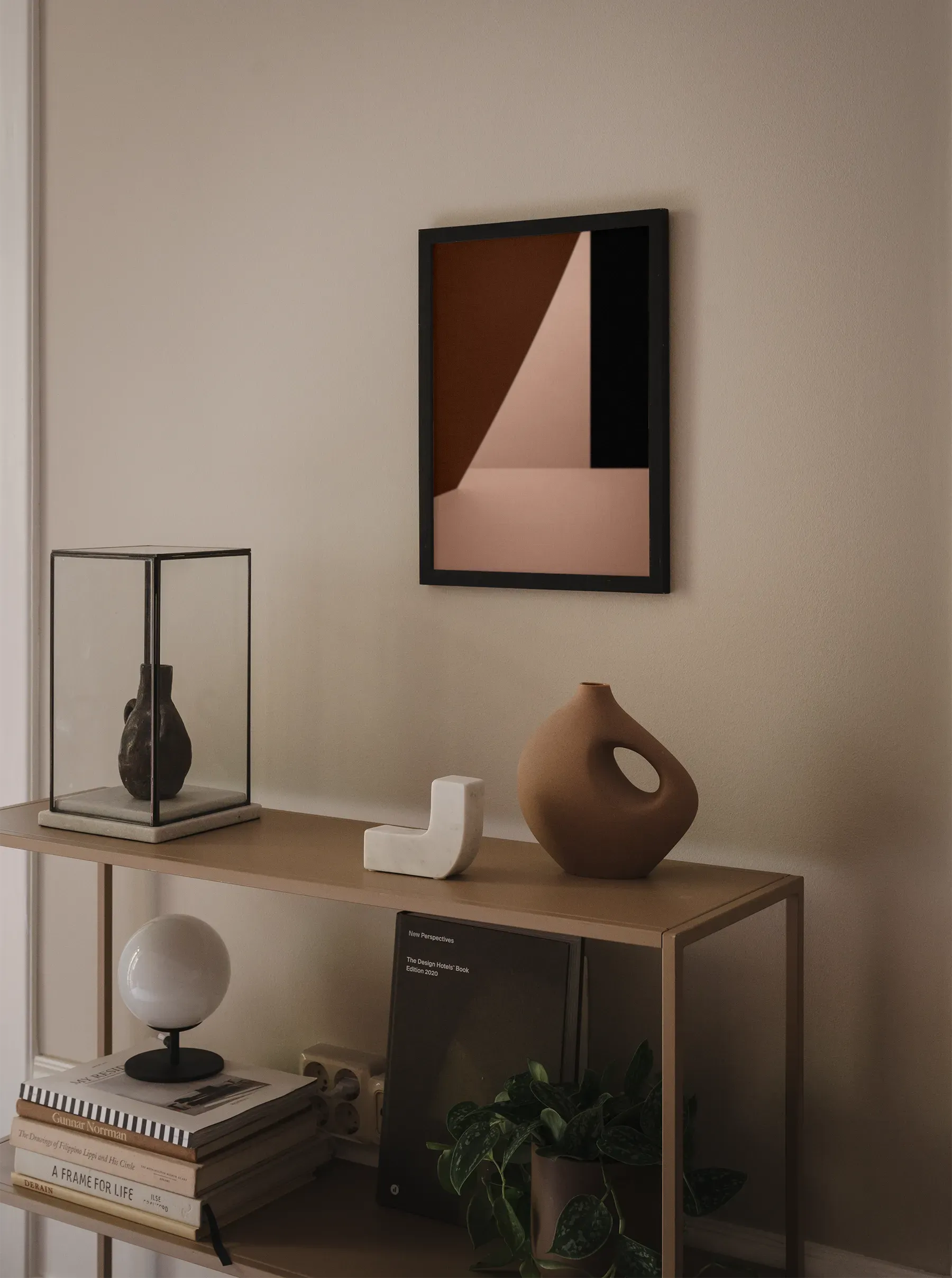 Modern Scandinavian interior with a framed red and beige geometric fine art print, styled with neutral decor and warm lighting. Printed in Sweden, exclusive at Monday Gallery.