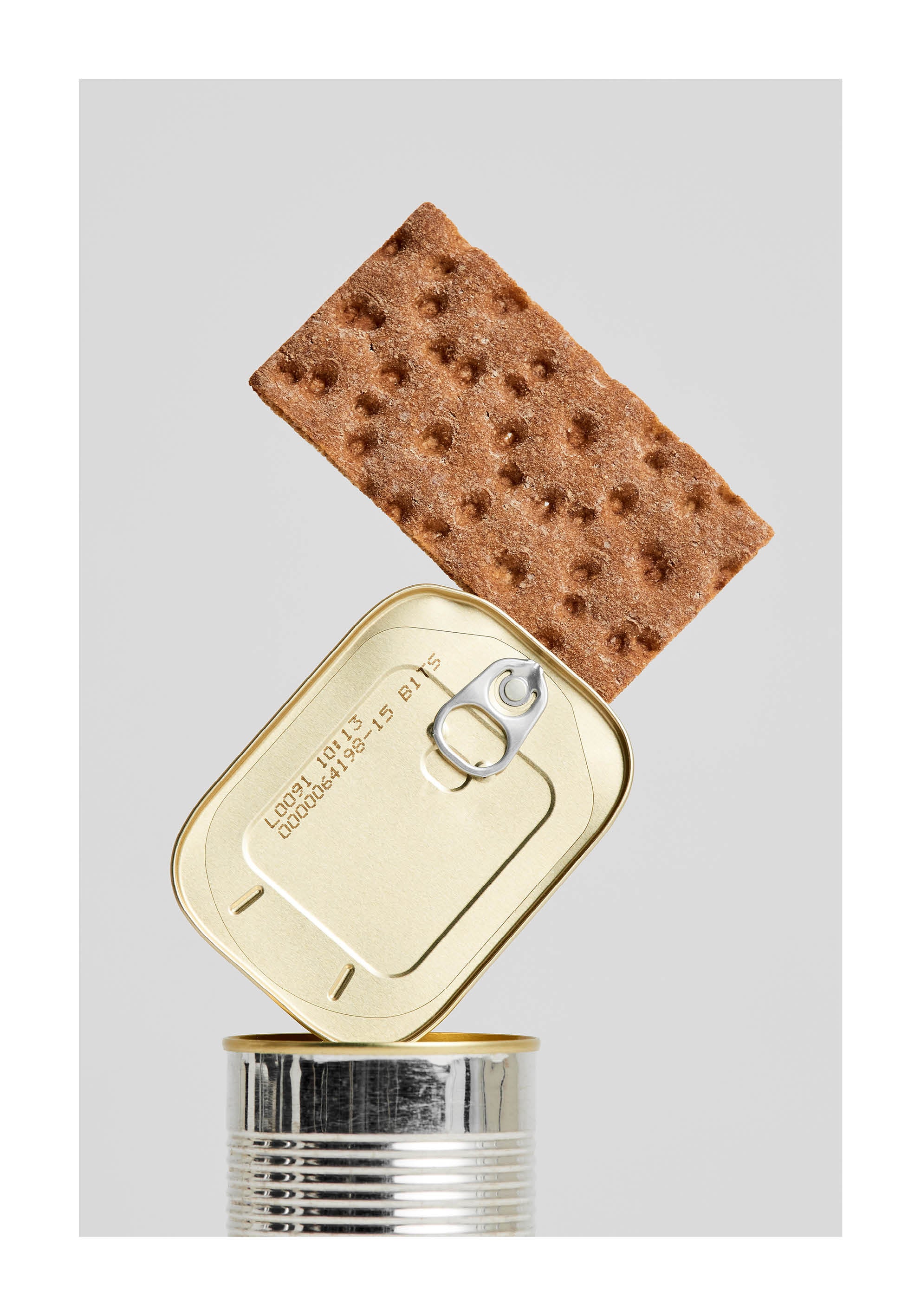 Conceptual fine art print featuring crispbread balanced on a tin can. Minimalist Scandinavian kitchen wall art from Monday Gallery.
