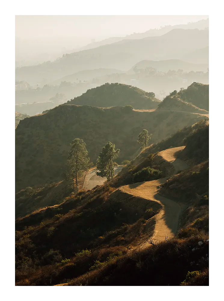 Minimalist landscape photograph of rolling Californian hills captured in warm, golden light.