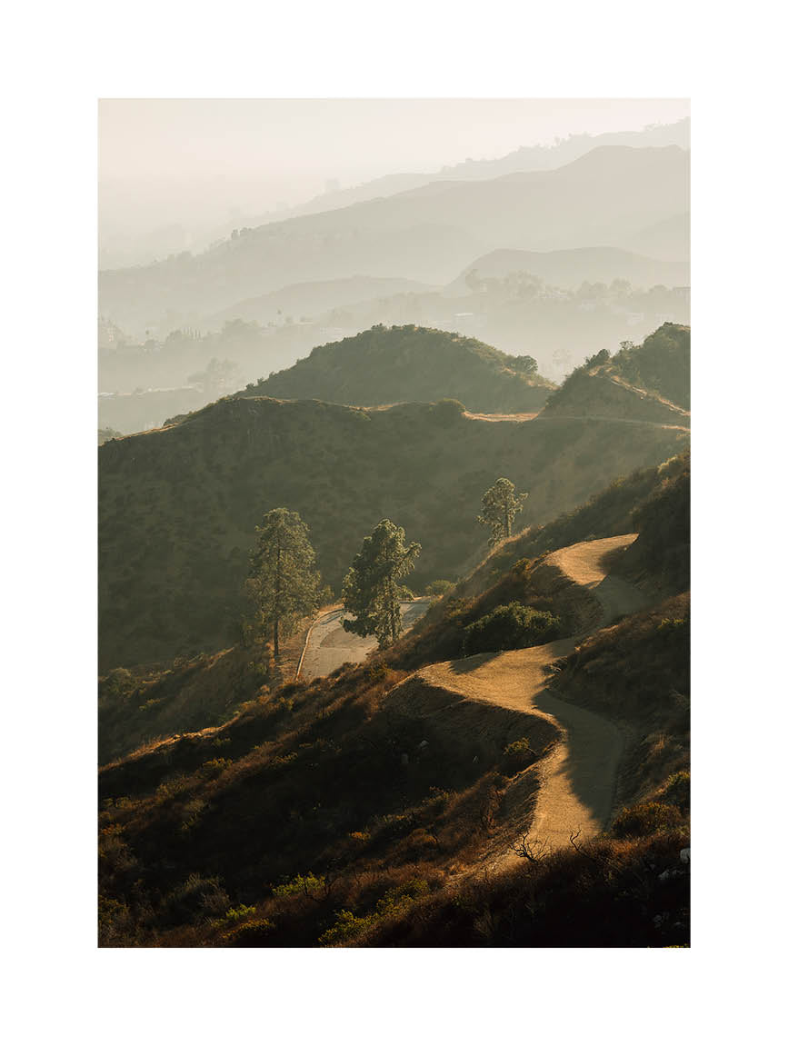 Minimalist landscape photograph of rolling Californian hills captured in warm, golden light.