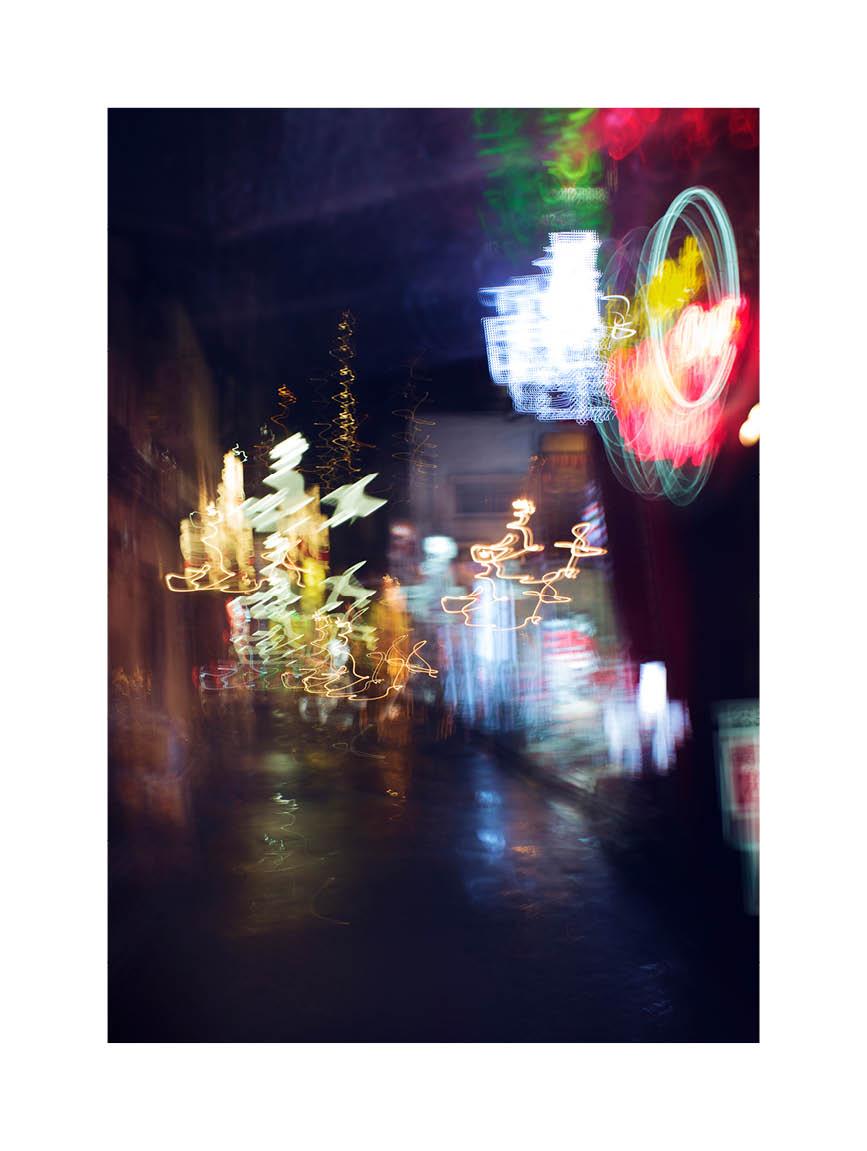 Fine art photograph of Tokyo at night with glowing neon lights and blurred reflections under the rain, printed in Sweden, exclusive at Monday Gallery.