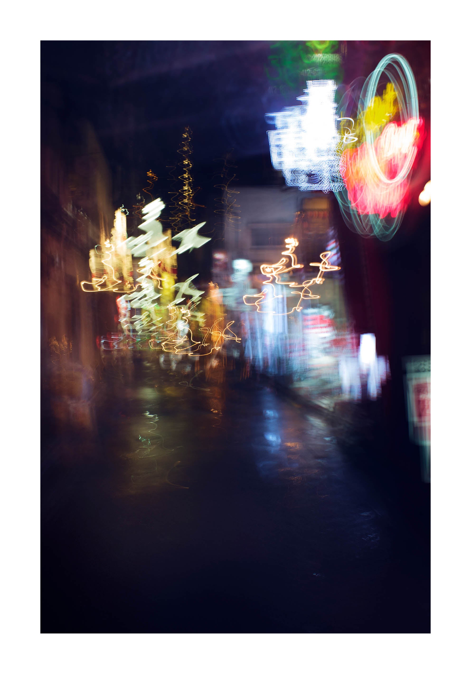 Fine art photograph of Tokyo at night with glowing neon lights and blurred reflections under the rain, printed in Sweden, exclusive at Monday Gallery.